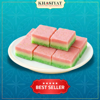 Stack of pink and green layered dessert on a white plate with 'Khasiyat' branding and 'Best Seller' label on a blue background.